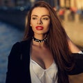 Attractive brunette woman posing against river on background Royalty Free Stock Photo