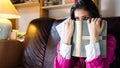 Attractive brunette woman student reading/ studying in her girly room