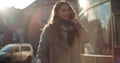 Attractive brunette young woman talking on phone while walking on a city street. Royalty Free Stock Photo