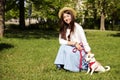 Attractive hipster young woman went for a walk in the park, playing with cute jack russell terrier puppy on clear sunny day. Royalty Free Stock Photo