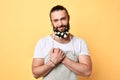 Attractive, brutal bearded cheerful man with flowers in beard