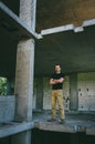 Attractive brutal man in black in an abandoned building. Stalker, lover of extreme adventures Royalty Free Stock Photo