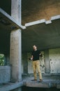 Attractive brutal man in black in an abandoned building. Stalker, lover of extreme adventures Royalty Free Stock Photo