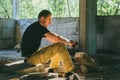 Attractive brutal man in black in an abandoned building. Stalker, lover of extreme adventures Royalty Free Stock Photo