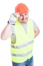 Attractive builder man holding helmet acting polite Royalty Free Stock Photo