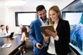 Attractive business couple using tablet in their company