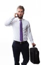 Attractive business man with a beard is walking and talking on a smart phone