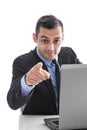 Attractive business man pointing finger at camera with laptop is Royalty Free Stock Photo