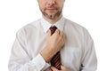 Attractive business man straightens his tie