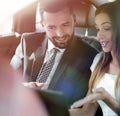 Smiling business people working in backseat of car Royalty Free Stock Photo