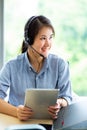 Attractive business woman Asian in suits and headsets are smiling while working with computer at office. Customer service Royalty Free Stock Photo