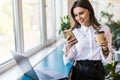 Attractive business woman drinking coffee in her office. Pretty young business woman having coffee at her workplace. Female Royalty Free Stock Photo