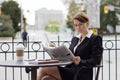 Attractive business woman reads the newspaper at outdoor cafe Royalty Free Stock Photo