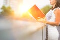 Attractive business woman reads real file outside, concept moden women working in business