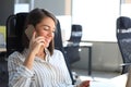 Attractive business woman talking with collegues on the mobile phone while sitting in the office desk Royalty Free Stock Photo