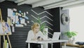 Attractive business woman uses the cell phone in modern office. Royalty Free Stock Photo