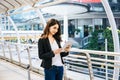 Attractive business woman using a digital tablet while standing in front of office Royalty Free Stock Photo