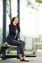 Attractive business woman waiting at bus stop Royalty Free Stock Photo