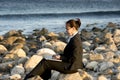 Attractive business woman working on laptop at beach Royalty Free Stock Photo