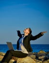 Attractive business woman working on laptop at beach Royalty Free Stock Photo