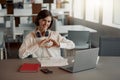 Attractive business woman working laptop while sitting in cozy cafe and showing sign love Royalty Free Stock Photo