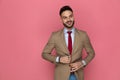 Attractive businessman arranging his jacket and looking away