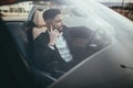 Attractive businessman with convertible car, using mobile Royalty Free Stock Photo