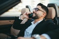 Attractive businessman with convertible car, using mobile Royalty Free Stock Photo