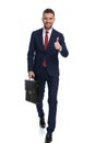 Businessman giving an ok sign and holding a case Royalty Free Stock Photo