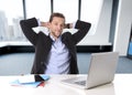 Attractive businessman happy at office work sitting at computer desk satisfied and smiling relaxed Royalty Free Stock Photo