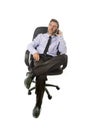 Attractive businessman leaning relaxed sitting on office chair talking on mobile phone Royalty Free Stock Photo