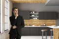 Attractive businessman in modern kitchen interior Royalty Free Stock Photo