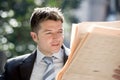 Attractive businessman sitting outdoors in breakfast pause early morning reading newspaper news looking relaxed Royalty Free Stock Photo