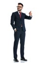 Businessman standing and pointing one way while looking the other Royalty Free Stock Photo