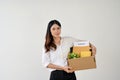 Attractive businesswoman carrying a cardboard box with her stuff and her resignation letter Royalty Free Stock Photo