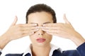 Attractive businesswoman covering her eyes