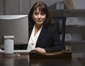 Attractive businesswoman at desk. Royalty Free Stock Photo