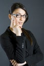 Attractive businesswoman with glasses thinking Royalty Free Stock Photo