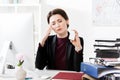 Attractive businesswoman having headache and holding bottle with pills Royalty Free Stock Photo