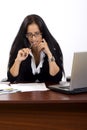 Attractive businesswoman on her desk holding a pen Royalty Free Stock Photo