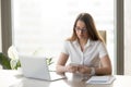 Attractive businesswoman holding smartphone, texting message, us