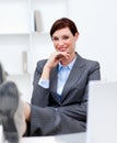 Attractive businesswoman leaning feet on desk Royalty Free Stock Photo