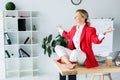 attractive businesswoman meditating in lotus pose on table