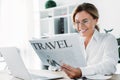attractive businesswoman reading travel newspaper Royalty Free Stock Photo