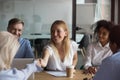 Attractive businesswoman shaking hand of business partner at meeting Royalty Free Stock Photo