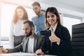 Attractive businesswoman smiling at the camera and showing thumb up during a business meeting Royalty Free Stock Photo