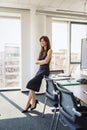 Attractive businesswoman standing in a modern office Royalty Free Stock Photo