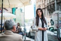 An attractive businesswoman standing outdoors on a sidewalk in a city. Royalty Free Stock Photo