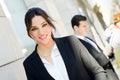 Attractive businesswoman standing outside of company building. C Royalty Free Stock Photo