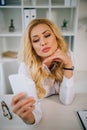 attractive businesswoman taking selfie at working place